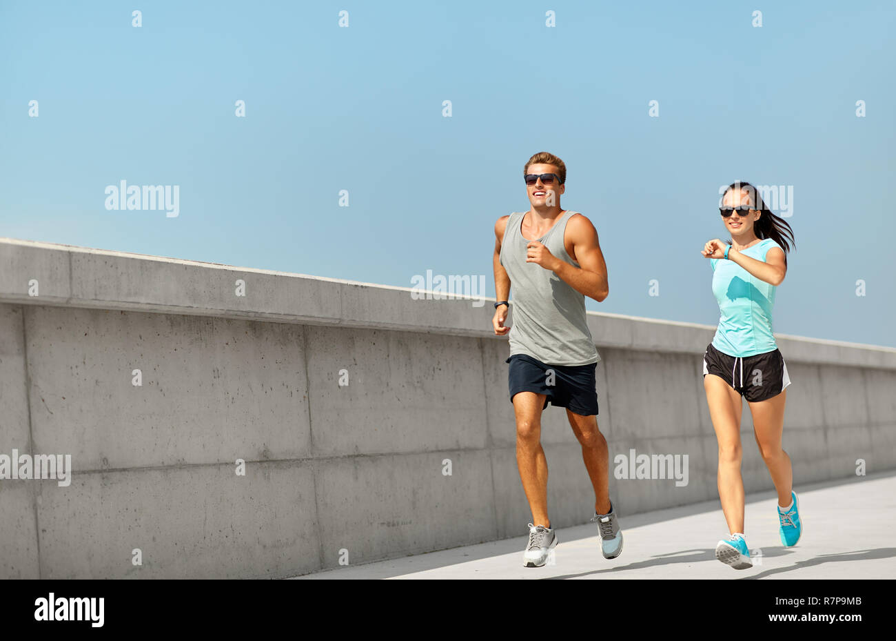 couple in sports clothes running outdoors Stock Photo - Alamy image.