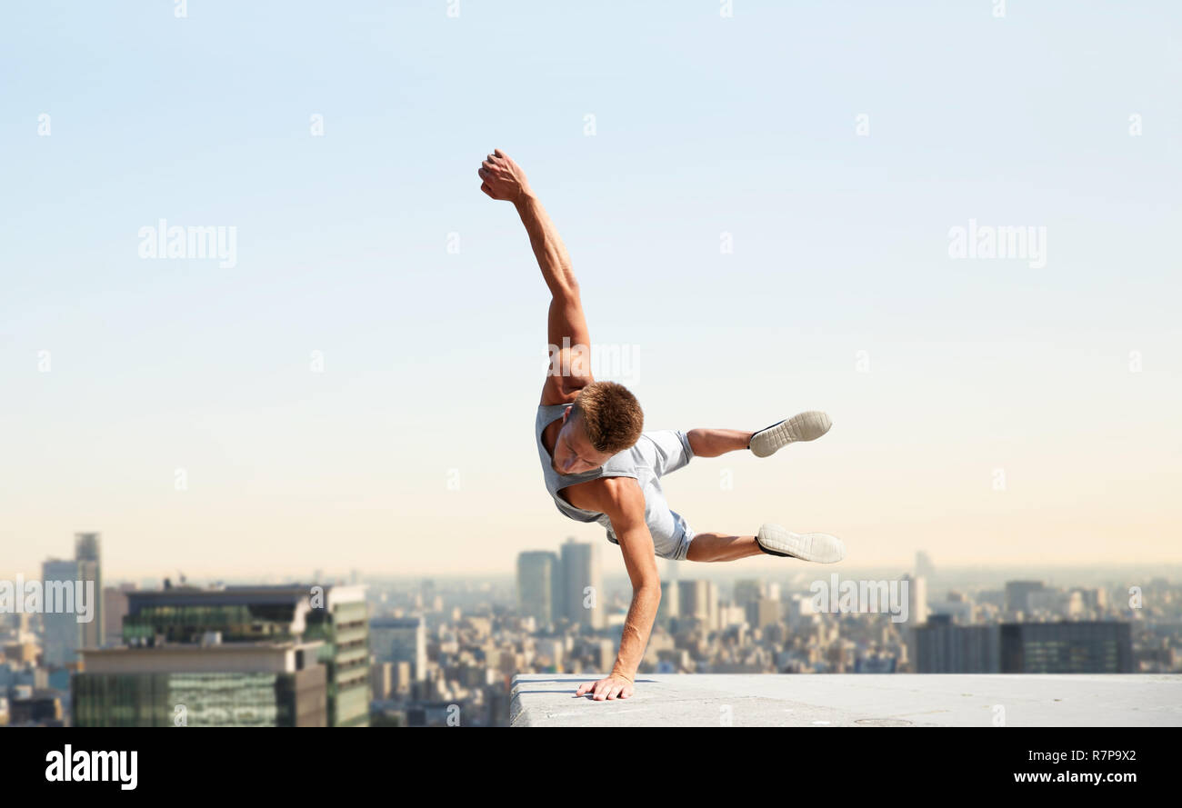 man making parkour jumping over tokyo city Stock Photo