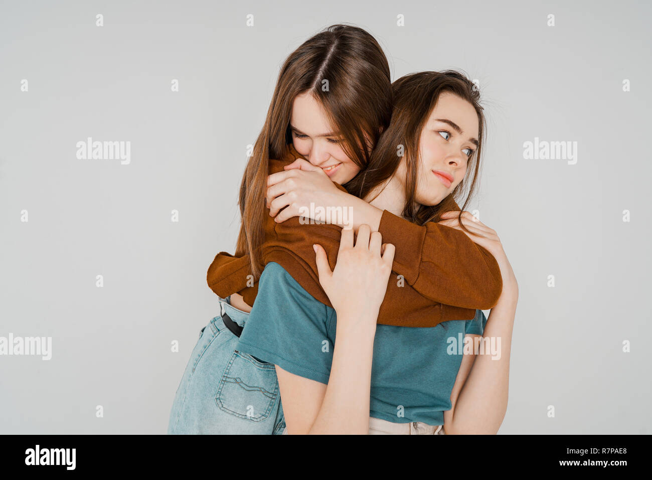 Two sisters twins beautiful girls hipsters in casual clothing on Stock Photo