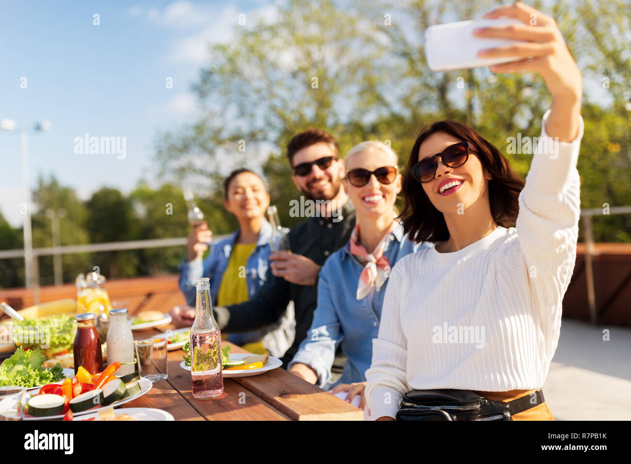 happy friends taking selfie at rooftop party Stock Photo - Alamy
