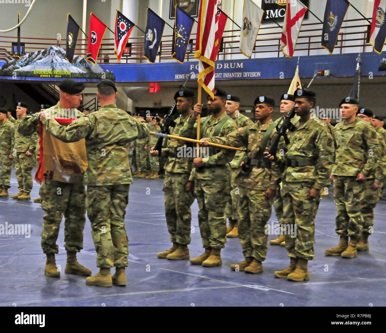 Maj. Thomas Pfarr and Master Sgt. Benjamin Brink furl the colors of the