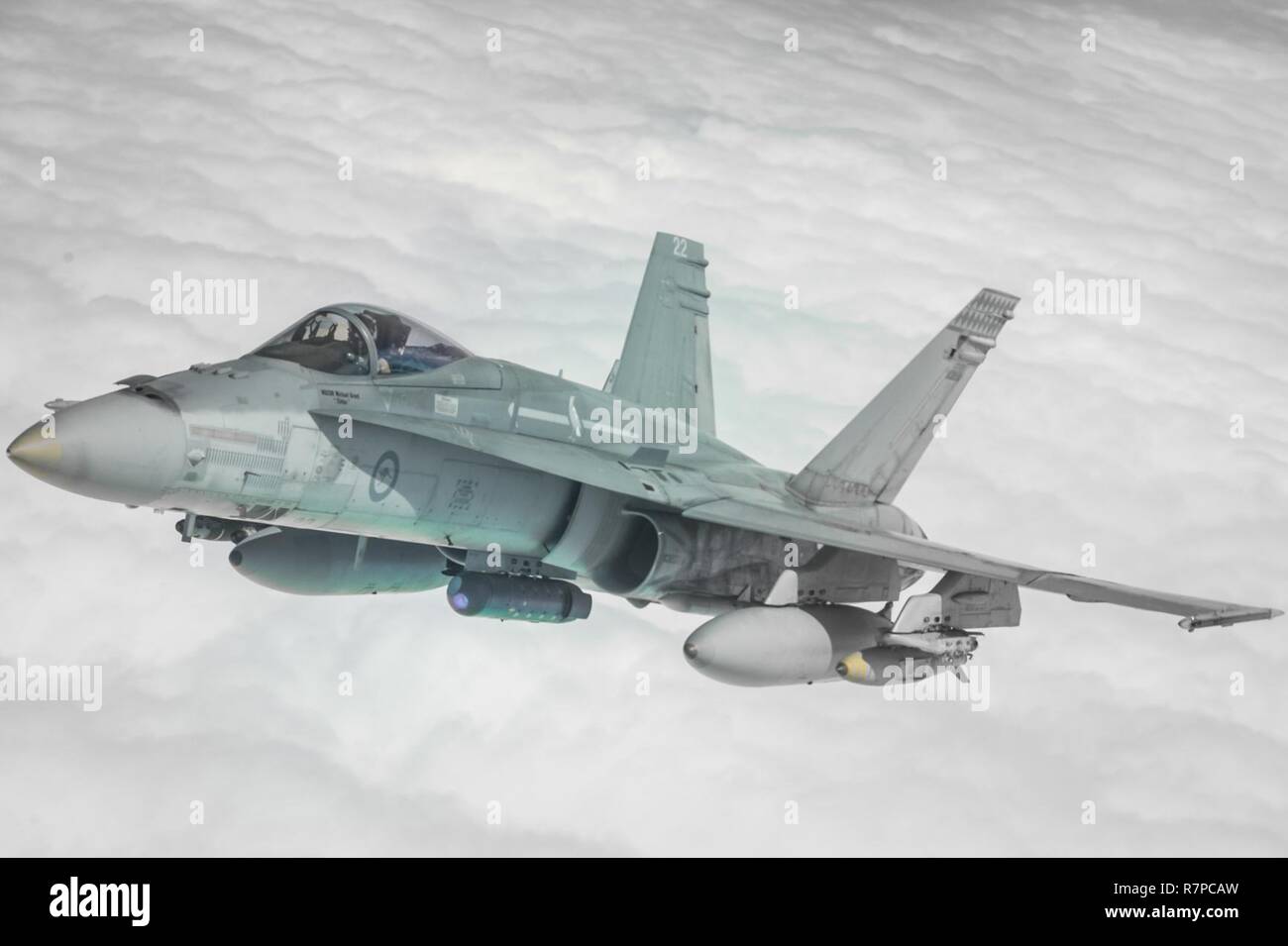 A Royal Australian Air Force F/A-18A Hornet receives fuel from a U.S ...