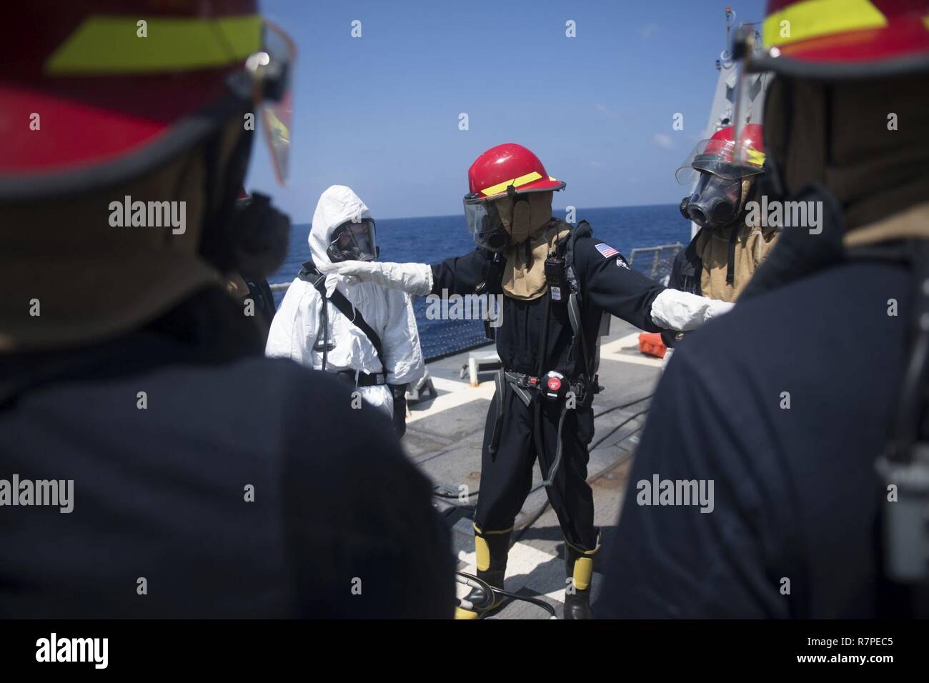 SOUTH CHINA SEA (March 20, 2017) Damage Controlman 2nd Class Terray Franklin, from Houston, directs Sailors during a toxic gas drill aboard Arleigh Burke-class guided-missile destroyer USS Michael Murphy (DDG 112). Michael Murphy is on a regularly scheduled Western Pacific deployment with the Carl Vinson Carrier Strike Group as part of the U.S. Pacific Fleet-led initiative to extend the command and control functions of U.S. 3rd Fleet. U.S. Navy aircraft carrier strike groups have patrolled the Indo-Asia-Pacific regularly and routinely for more than 70 years. Stock Photo