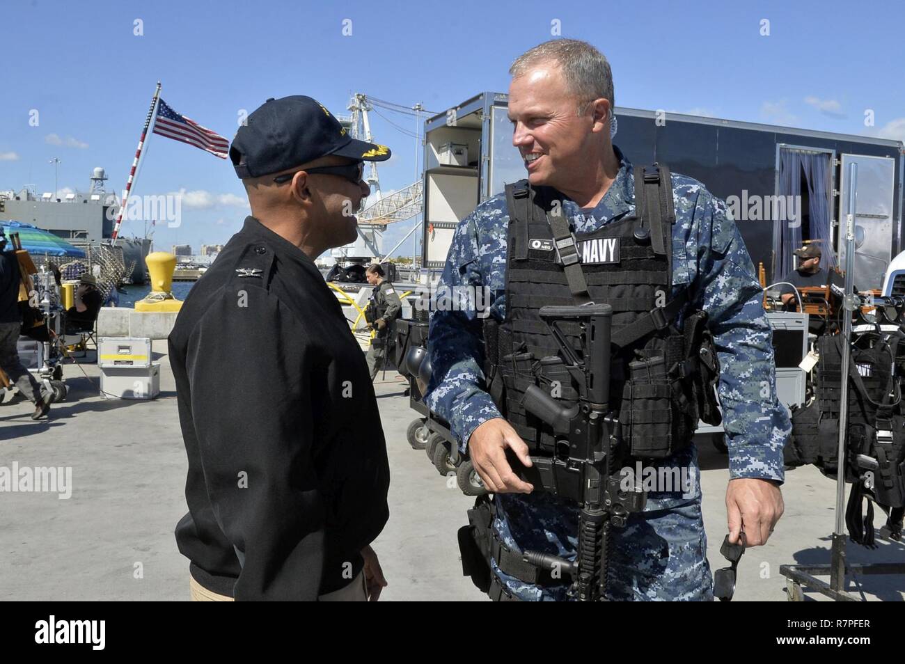 SAN DIEGO (March 23, 2017) Naval Base San Diego Commanding Officer Capt. Roy Love greets actor Adam Baldwin prior to the filming of the television show 'The Last Ship' on board the guided Stock Photo