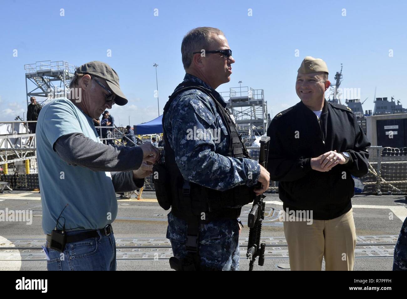 SAN DIEGO (March 23, 2017) Naval Base San Diego Command Master Chief Matt Ruane explains the history of the California naval base to actor Adam Baldwin prior to the filming of the television show 'The Last Ship'. Stock Photo