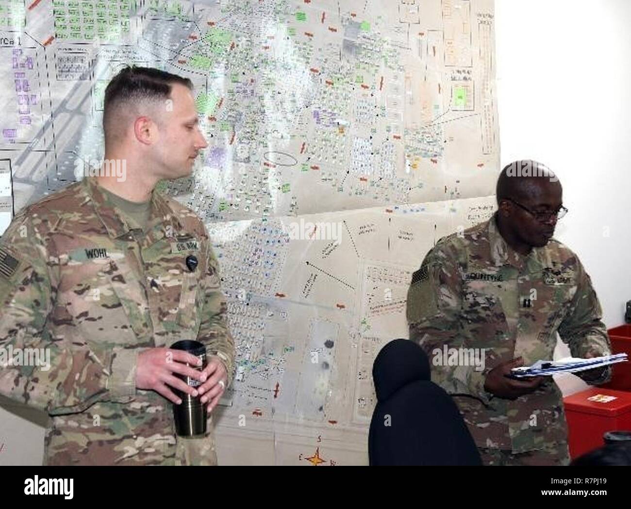 Army Sgt. Kevin Wohl (left), respiratory care specialist, and Army Capt. Grantley Quintyne (right), public health nurse, both Soldiers with the 31st Combat Support Hospital, explain what will occur during the Tobacco Cessation Program’s classroom presentation, March 24, at Camp Arifjan, Kuwait. Soldiers participating in the Tobacco Cessation Program are asked to participate in four classroom sessions which emphasize the value of being smoke free to the individual’s mind and body. Stock Photo