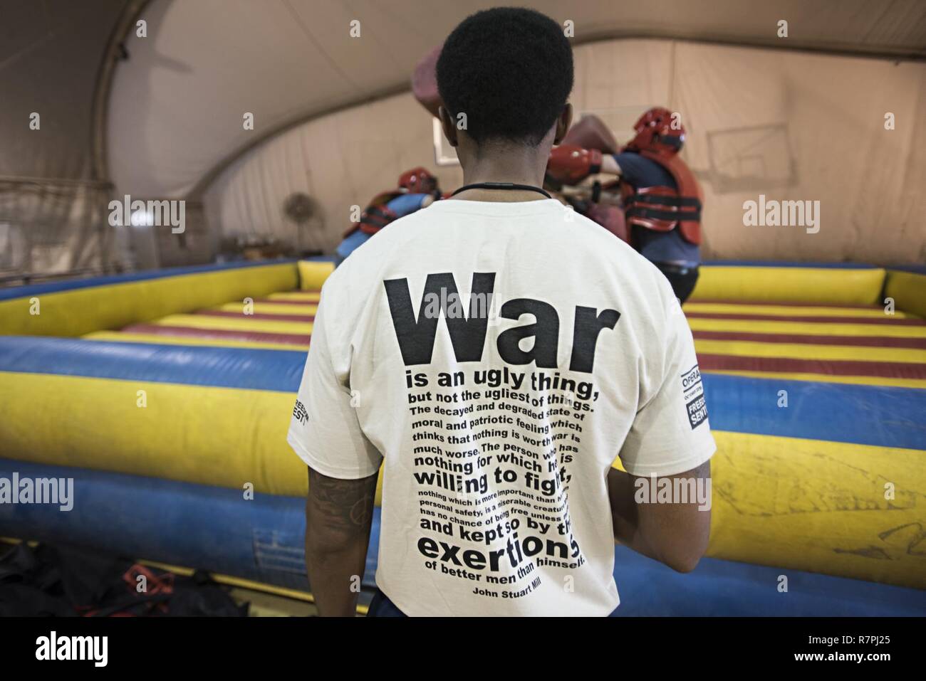 Staff Sgt. Darius Lester, 455th Air Expeditionary Wing comptroller, referees a big-glove boxing match March 25, 2017 at Bagram Airfield, Afghanistan. The match was part of Freedom Fest, an event held as an end-of-tour celebration. Stock Photo