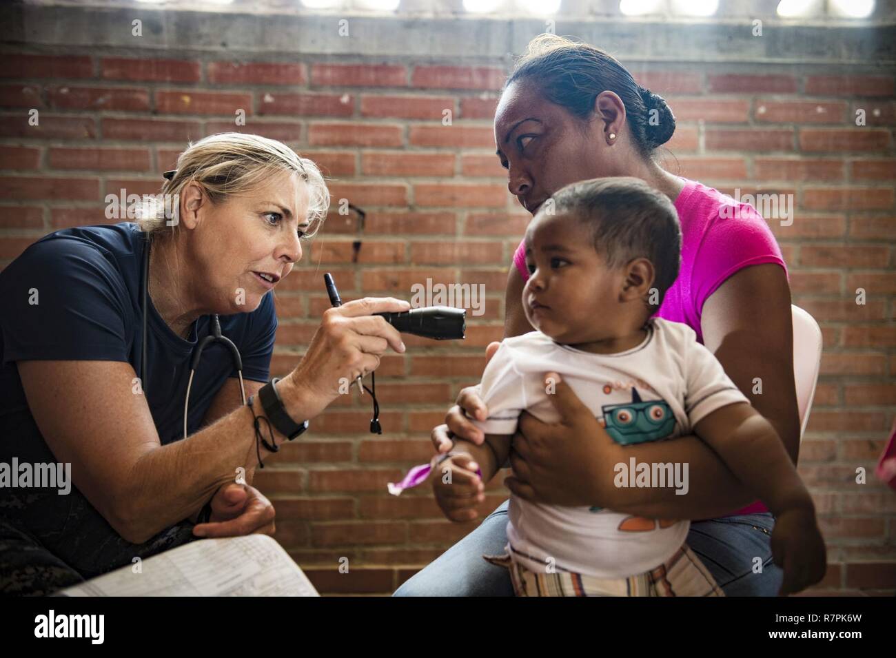 us navy cmdr ellen argo a native of alexandria va assigned to naval health clinic quantico va examines a child at the continuing promise 2017 cp 17 medical site in mayapo colombia march 22 2017 cp 17 is a us southern command sponsored and us naval forces southern commandus 4th fleet conducted deployment to conduct civil military operations including humanitarian assistance training engagements medical dental and veterinary support in an effort to show us support and commitment to central and south america R7PK6W