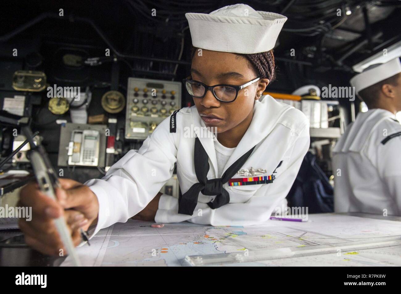 COLOMBO, Sri Lanka (March 27, 2017) Quartermaster 3rd Class Tyler Terrell,  from Atlanta, plots a course during watch on the bridge of the amphibious  dock landing ship USS Comstock (LSD 45) as