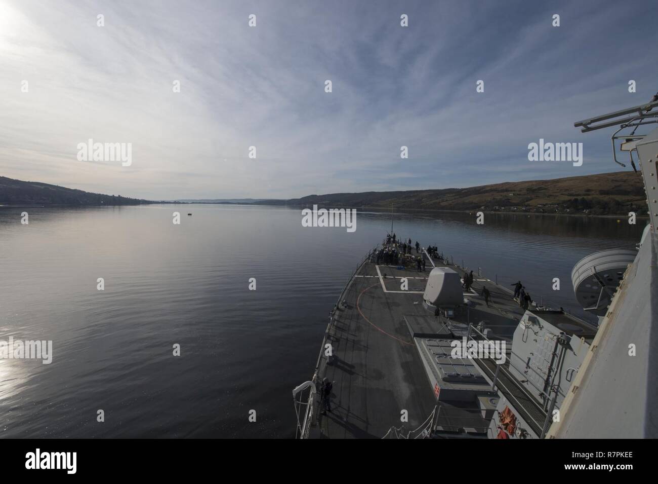 FASLANE, Scotland - (March 26, 2017) - USS Carney (DDG 64) gets underway from Faslane, Scotland March 26, 2017. Carney, an Arleigh Burke-class guided-missile destroyer, forward-deployed to Rota, Spain, is conducting its third patrol in the U.S. 6th Fleet area of operations in support of U.S. national security interests in Europe. Stock Photo