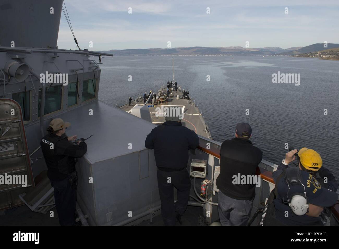 FASLANE, Scotland (March 26, 2017)  Sailors aboard the guided-missile destroyer USS Carney (DDG 64) stand watch on the bridge wing while departing Faslane, Scotland.  Carney is forward-deployed to Rota, Spain, and is conducting its third patrol in the U.S. 6th Fleet area of operations in support of U.S. national security interests in Europe. Stock Photo