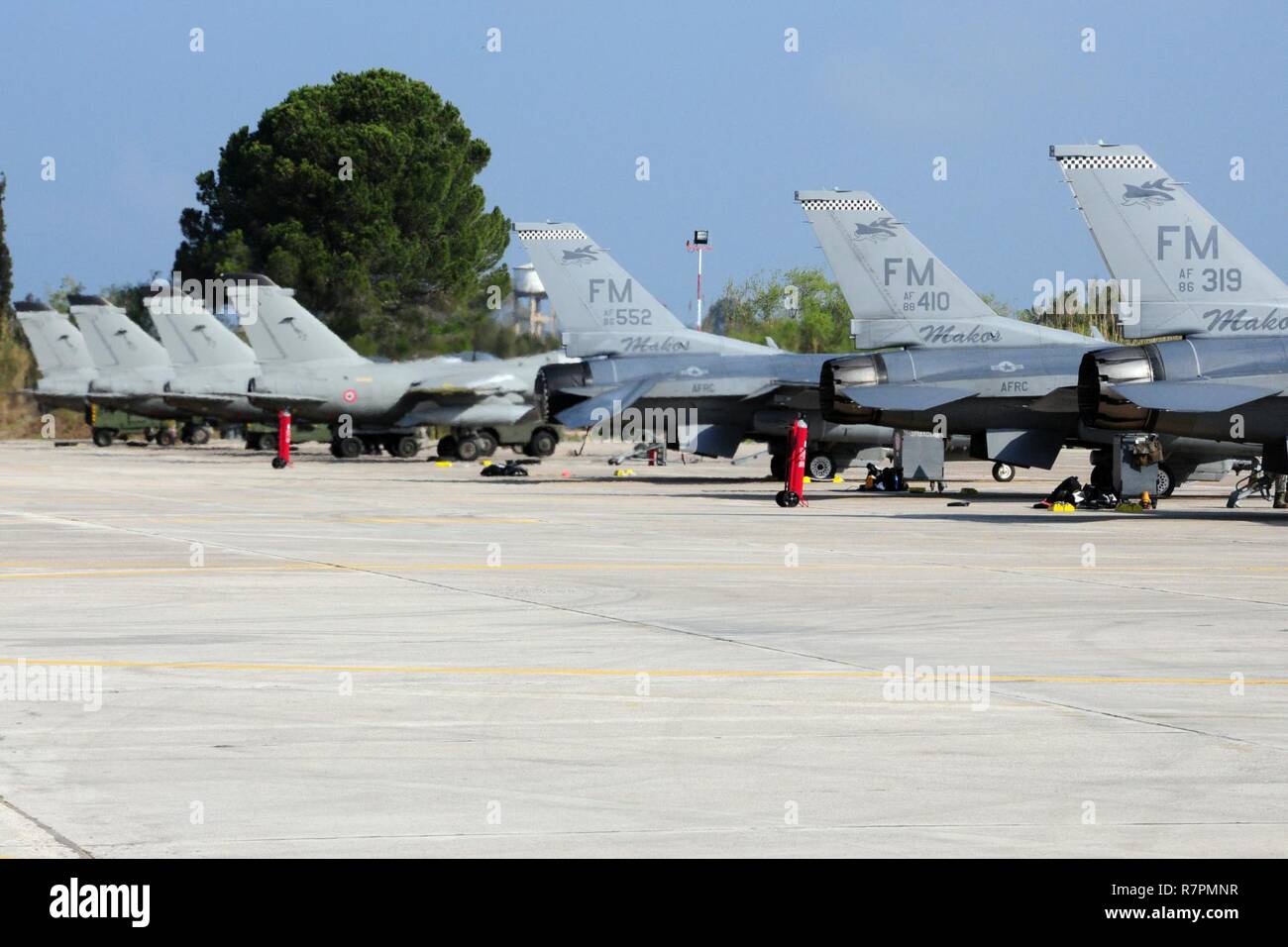 Italian and U.S. Air Force F-16Cs are parked on the flightline at Andravida Air Base Greece, Mar. 27, 2017 during INIOHOS 17.  The U.S. and Greece, as NATO allies, are participating in this exercise to promote peace and stability, and to seek opportunities to continue developing  a relationship. Stock Photo