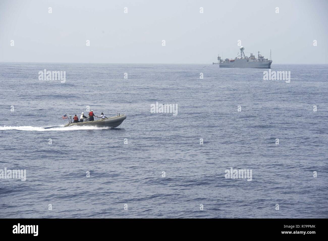 SOUTH CHINA SEA (March 23, 2017) Crew members of the forward-deployed Arleigh Burke-class guided-missile destroyer USS Fitzgerald (DDG 62) drive a rigid hull inflatable boat (RHIB) during a personnel transfer. Fitzgerald is in the U.S. 7th Fleet area of operations supporting security and stability in the Indo-Asia-Pacific region. Stock Photo
