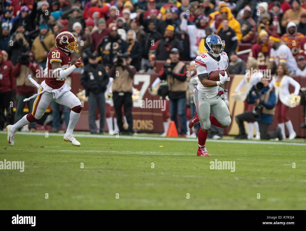 New York Giants running back Saquon Barkley (26) keeps his hands warm while  on the sidelines in the third quarter against the Washington Redskins at  FedEx Field in Landover, Maryland on Sunday