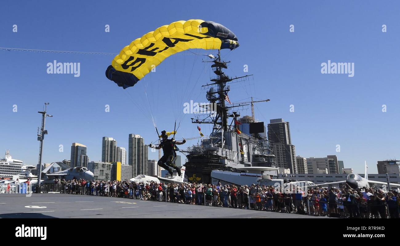 Retired U.S. Navy SEAL Jim Woods, a member of the U.S. Navy Parachute Team, the Leap Frogs, comes in for a landing during a skydiving demonstration above the USS Midway Museum in San Diego March 29, 2017. The Leap Frogs are based in San Diego and perform aerial parachute demonstrations around the nation in support of Naval Special Warfare and Navy recruiting. Stock Photo