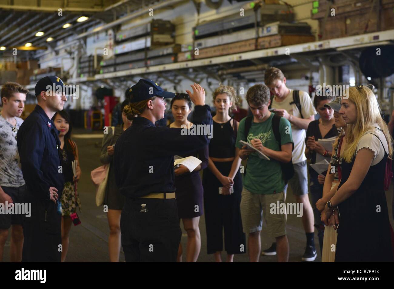 MAYPORT, Fla. (March 29, 2017) - Ens. Kimberly King leads students from the Department of Geography at University College London on a tour of the amphibious assault ship USS Iwo Jima (LHD 7). Iwo Jima recently returned to her homeport after conducting a series of certifications and qualifications in preparation for future deployments. Stock Photo