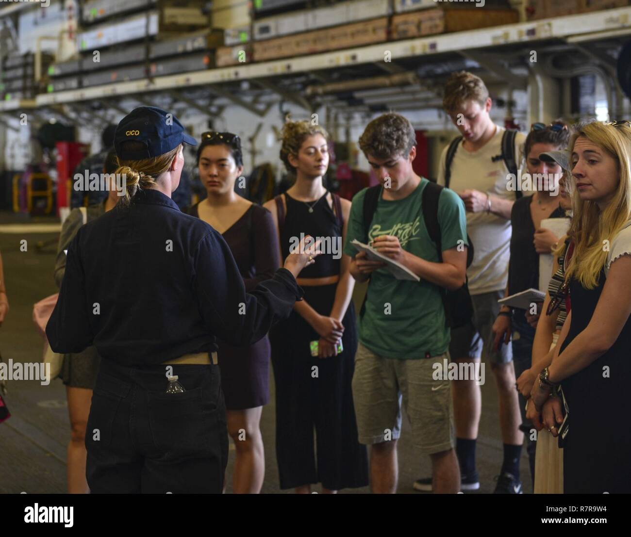 MAYPORT, Fla. (March 29, 2017) - Ens. Kimberly King leads students from the Department of Geography at University College London on a tour of the amphibious assault ship USS Iwo Jima (LHD 7). Iwo Jima recently returned to her homeport after conducting a series of certifications and qualifications in preparation for future deployments. Stock Photo