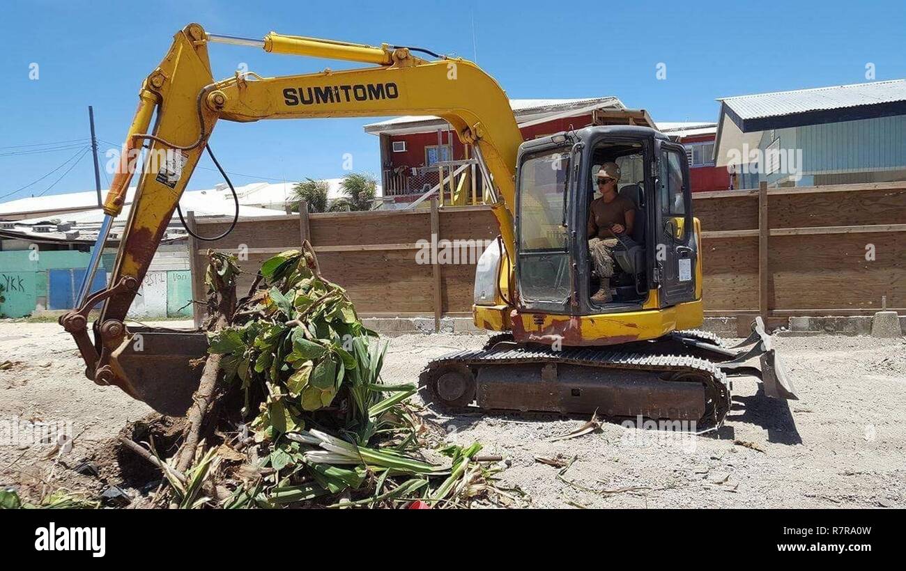 EBEYE, Republic of the Marshall Islands (March 30, 2017) Equipment Operator 3rd Class Johanna Pasutin, from La Habra, California, assigned to Naval Mobile Construction Battalion (NMCB) 1, removes rubble with an excavator from the construction site for a three classroom school building on the island of Ebeye, Republic of the Marshall Islands, March 30, 2017. NMCB 1 is forward deployed to execute construction, humanitarian and foreign assistance, special operations combat service support, and theater security cooperation in support of U.S. Pacific Command Stock Photo