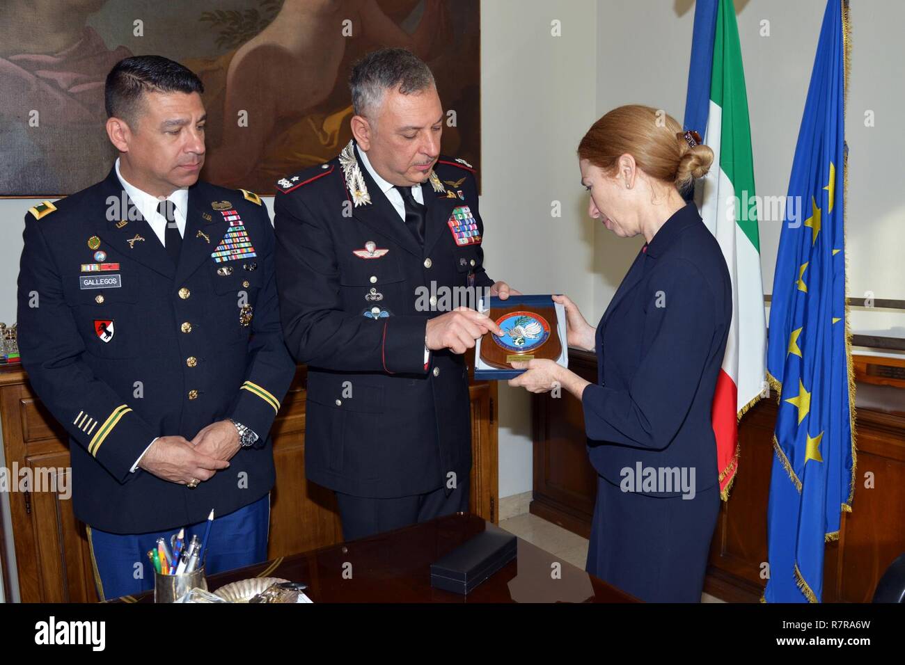 Brig. Gen. Giovanni Pietro Barbano, Center of Excellence for Stability Police Units (CoESPU) director (center) and U.S. Army Col. Darius S. Gallegos, CoESPU deputy director (left), presents Carabinieri CoESPU crest to Ms. Kelly Degnan, Charge’ d’Affaires ad interim U.S. Embassy & Consulates Italy, during visit at Center of Excellence for Stability Police Units (CoESPU) Vicenza, Italy, Mar. 30, 2017. Stock Photo