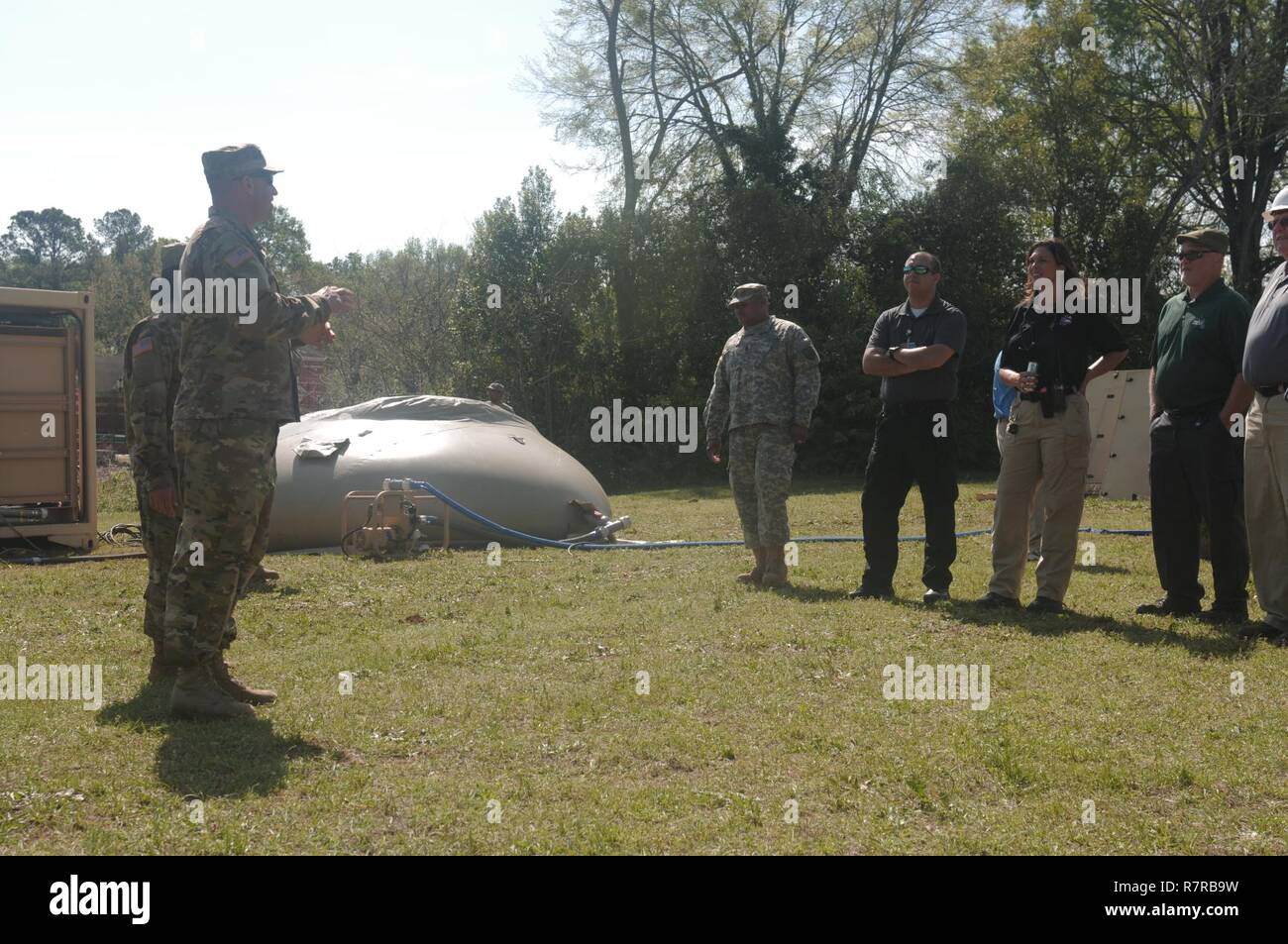 AUGUSTA, Ga., March 29, 2017 -  Georgia Army National Guardsman Capt. Matthew Arnold, from the 348th Brigade Support Battalion, speaks with civilian emergency services personnel about the Tactical Water Purification System and the team that supports the operation of the equipment. The National Guard trains with other agencies to improve interoperability in the event of an emergency during Vigilant Guard 17. Stock Photo