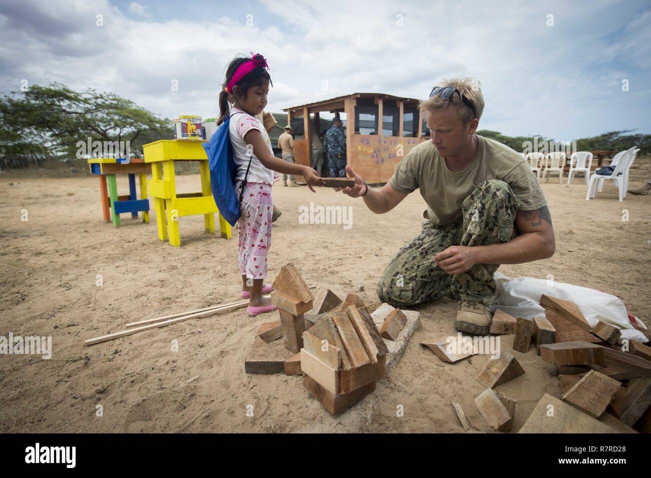 MAYAPO, Colombia (March 30, 2017) - Utilitiesman 2nd Class Elliott Shultz, a native of Indianapolis assigned to Construction Battalion Maintenance Unit (CBMU) 202, Norfolk, Va., plays with a child from a Wayuu tribe in Mayapo, Colombia, during Continuing Promise 2017 (CP-17). CP-17 is a U.S. Southern Command-sponsored and U.S. Naval Forces Southern Command/U.S. 4th Fleet-conducted deployment to conduct civil-military operations including humanitarian assistance, training engagements, medical, dental, and veterinary support in an effort to show U.S. support and commitment to Central and South A Stock Photo