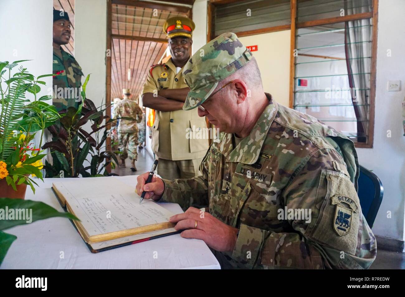 U.S. Army Brig. Gen. Kenneth Moore, U.S. Army Africa deputy commander, signs the guest book at the Malawi Armed Forces College near Salima, Malawi, during the final planning event for the Africa Land Forces Summit 2017, March 28, 2017. ALFS is an annual, weeklong seminar bringing together land force chiefs from across Africa for candid dialog to discuss and develop cooperative solutions to regional and trans-regional challenges and threats. Stock Photo