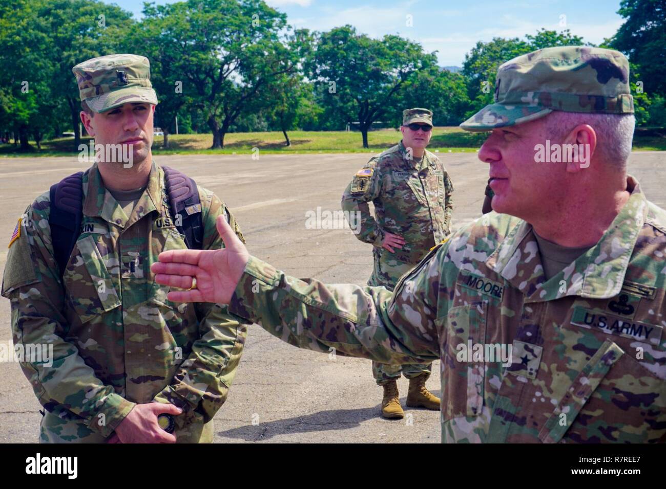 1st Lt. Christopher Bolin, aide to the U.S. Army Africa deputy commander,  watches Brig. Gen. Kenneth Moore, U.S. Army Africa deputy commander, give a  brief near the Malawi Armed Forces College, Salima,