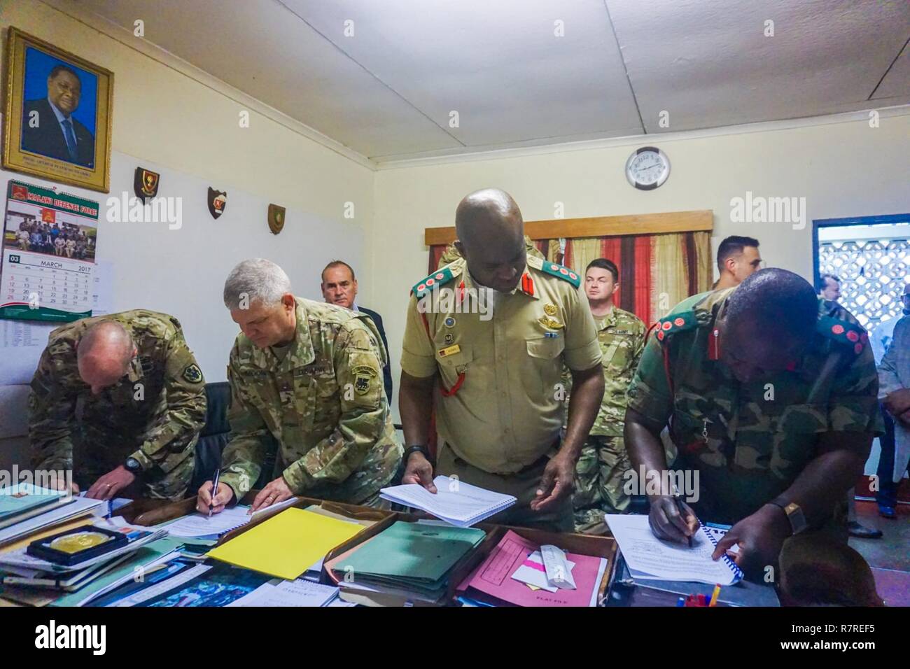 U.S. Army Brig. Gen. Kenneth Moore (second from left), U.S. Army Africa deputy commander, and Malawi Brig. Gen. Paul Phiri (right) sign the memorandum of understanding between the U.S. Army and Malawi Defense Force at the Kumuzu Barracks, Lilongwe, Malawi, during the final planning event for the Africa Land Forces Summit 2017, March 29, 2017. ALFS is an annual, weeklong seminar bringing together land force chiefs from across Africa for candid dialog to discuss and develop cooperative solutions to regional and trans-regional challenges and threats. Stock Photo