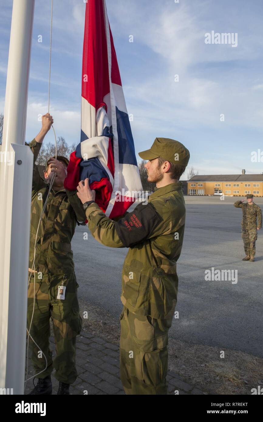 Soldiers with Home Guard 12 fly the Norwegian flag at Vaernes Garnison, March 30, 2017. Marine Rotational Force Europe 17.1 (MRF-E) upholds traditions as Marines and sailors operate from Norway, galvanizing the Marine Corps’ long and close relationship with the Norwegian Armed Forces. Stock Photo