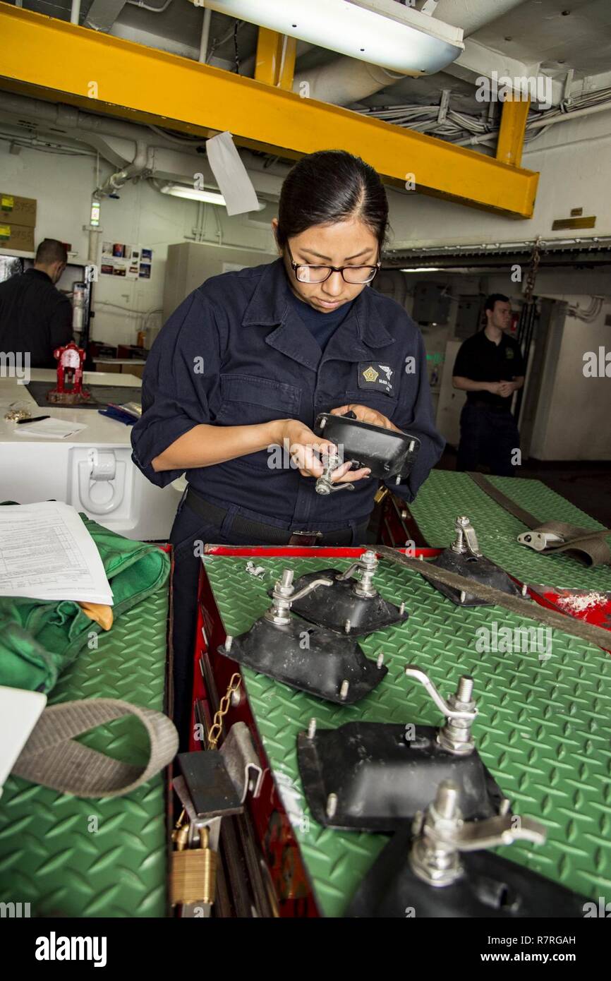 ATLANTIC OCEAN (April 1, 2017) Aviation Support Equipment Technician Airman Maya Condori, from Youngstown, Ohio, inspects the handle for an aircraft tow tractor aboard the aircraft carrier USS Dwight D. Eisenhower (CVN 69) (Ike). Ike and its carrier strike group are currently underway conducting a sustainment exercise in support of the Optimized Fleet Response Plan (OFRP). Stock Photo