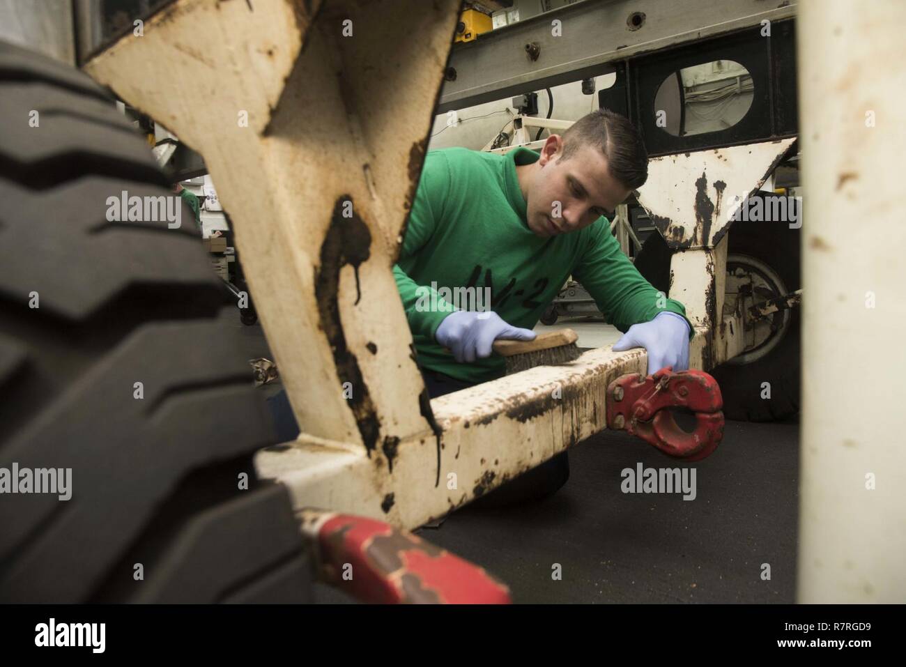 ATLANTIC OCEAN (March 31, 2017) Aviation Machinist's Mate Airman Jose Torrech, from Puerto Rico, cleans a run trailer in the jet shop aboard the aircraft carrier USS Dwight D. Eisenhower (CVN 69) (Ike). Ike and its carrier strike group are underway conducting a sustainment exercise in support of the Optimized Fleet Response Plan (OFRP). Stock Photo