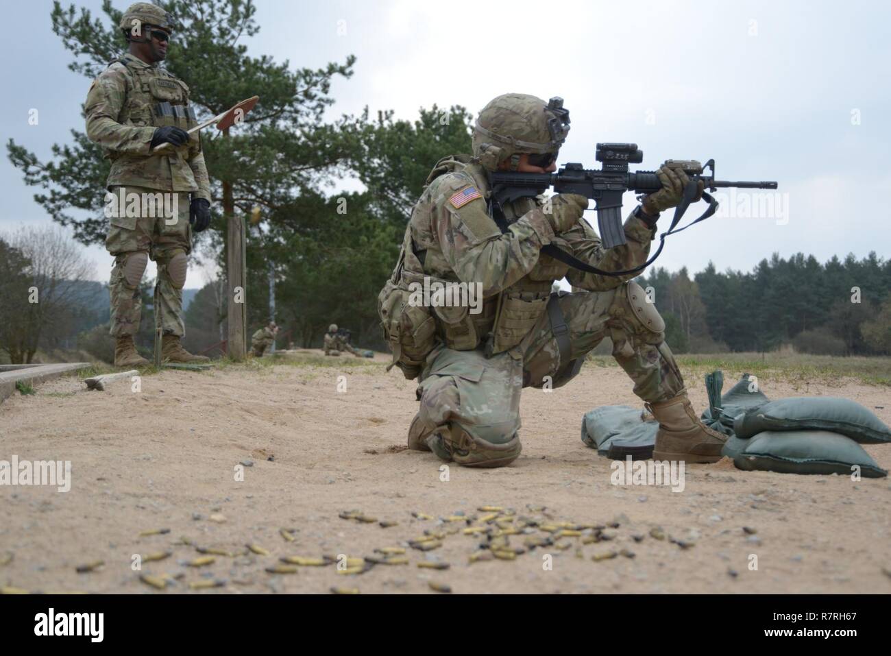 A U.S. Soldier, assigned to 3rd Squadron, 2nd Cavalry Regiment, fires a M4A1 carbine rifle during a small arms range at the 7th Army Training Command's Grafenwoehr Training Area, Germany, Apr. 04, 2017. Stock Photo