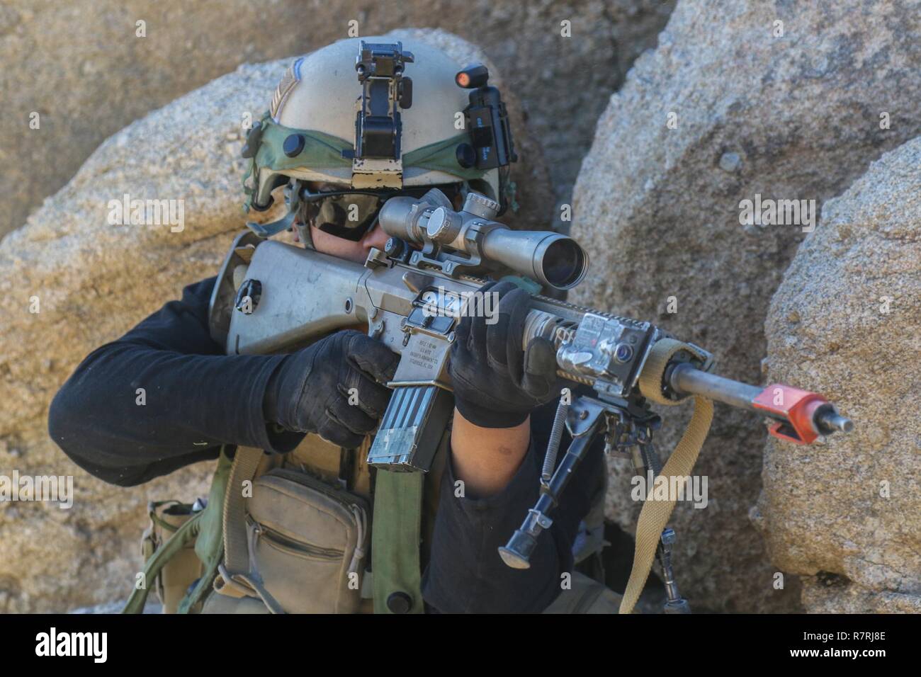 FORT IRWIN, Calif. – A Soldier from Coldsteel Troop, 1st Squadron, 11th Armored Cavalry Regiment, portraying a Bilausavar Freedom Brigade sniper, targets elements of the 1st Armored Brigade Combat Team, 3rd Infantry Division, during their assault on the city of Razish in the National Training Center, April 4, 2017. This phase of NTC Rotation 17-05 tested the “Raiders” Brigade’s ability to seize and capture an urban objective. Stock Photo