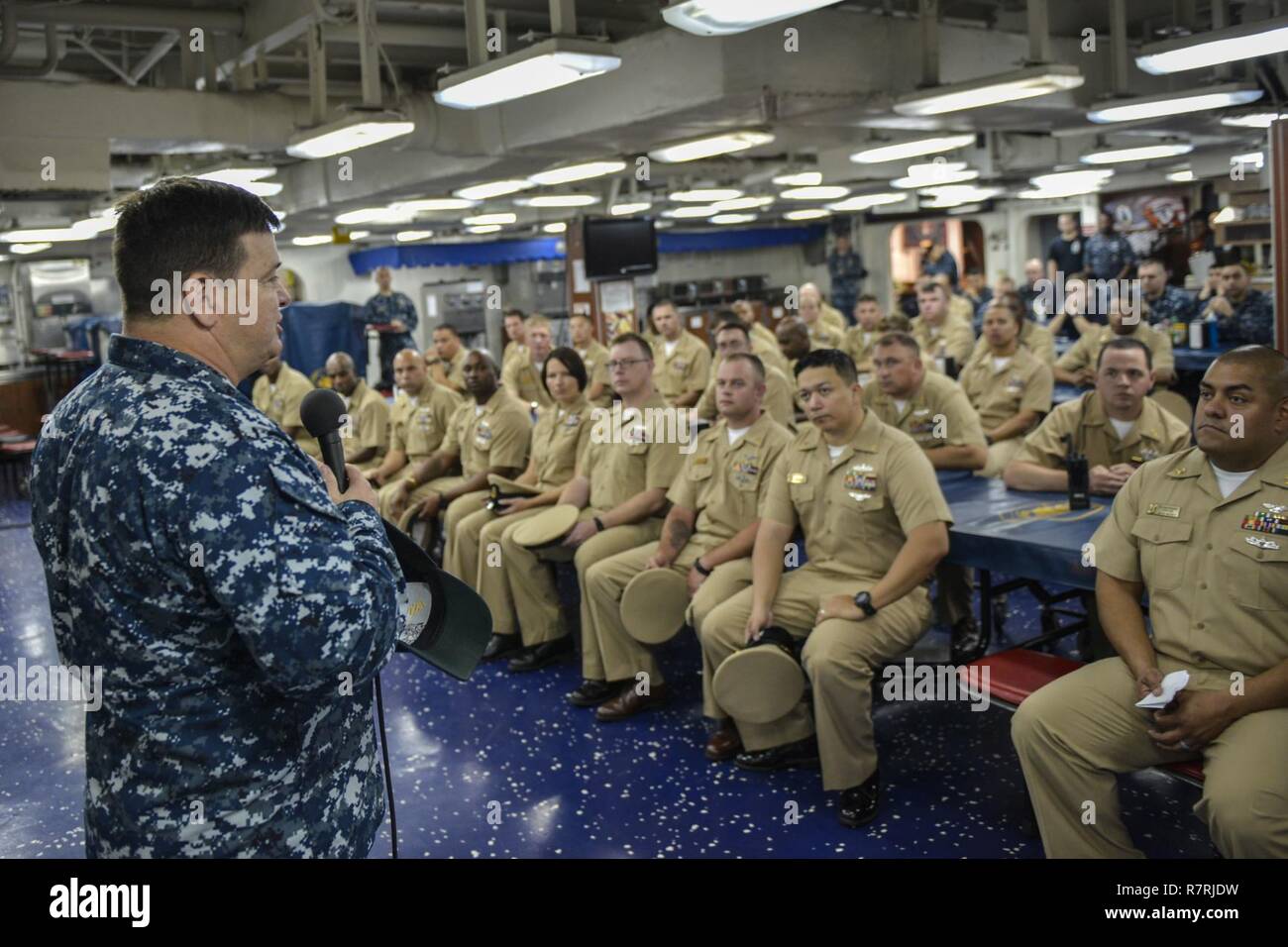 MAYPORT, Fla. (March 31, 2017) Capt. James R. Midkiff, commanding officer of the amphibious assault ship USS Iwo Jima (LHD 7), speaks with the ship's chief petty officers during a celebration for the 124th birthday of the chief petty officer rank. Iwo Jima recently returned from conducting a series of qualifications and certifications as part of the basic phase of training in preparation for future operations and deployments. Stock Photo