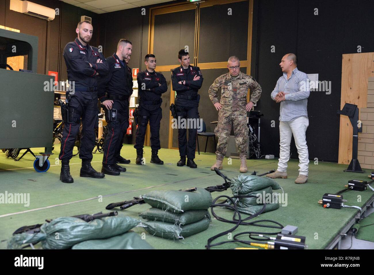 Joseph Gallegos, Training Specialist, Training Support Center Italy, shows the Engagement Skills Trainer (EST) to the Italian Carabinieri of the 13th Regiment Carabinieri “ Friuli Venezia Giulia” Gorizia, during the training at Caserma Ederle, April 3, 2017, Vicenza, Italy. Carabinieri use U.S. Army RTSD South equipment to enhance bilateral relations and to expand levels of cooperation and the capacity of the personnel involved in joint operations. Stock Photo
