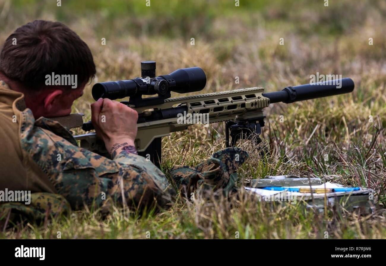 A Marine reloads an M40A6 rifle during an urban sniper course at Camp Lejeune, N.C., March 30, 2017. The Marines practiced engaging targets from unknown distances to maintain their skills on the weapon. The course, taught by Expeditionary Operations Training Group, includes Marines from 2nd Battalion, 6th Marine Regiment, 2nd Reconnaissance Battalion and School of Infantry-East. Stock Photo