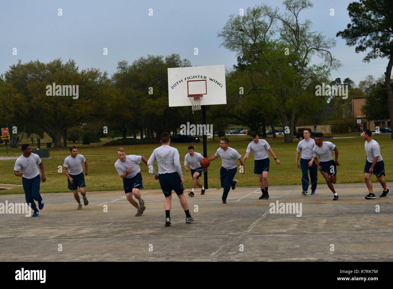 U.S. Airmen assigned to the 20th Logistics Readiness Squadron vehicle maintenance flight play basketball at Shaw Air Force Base, S.C., April 5, 2017. Unit physical training can promote teamwork and improve physical fitness, supporting the physical and social domains of Comprehensive Airmen Fitness. Stock Photo