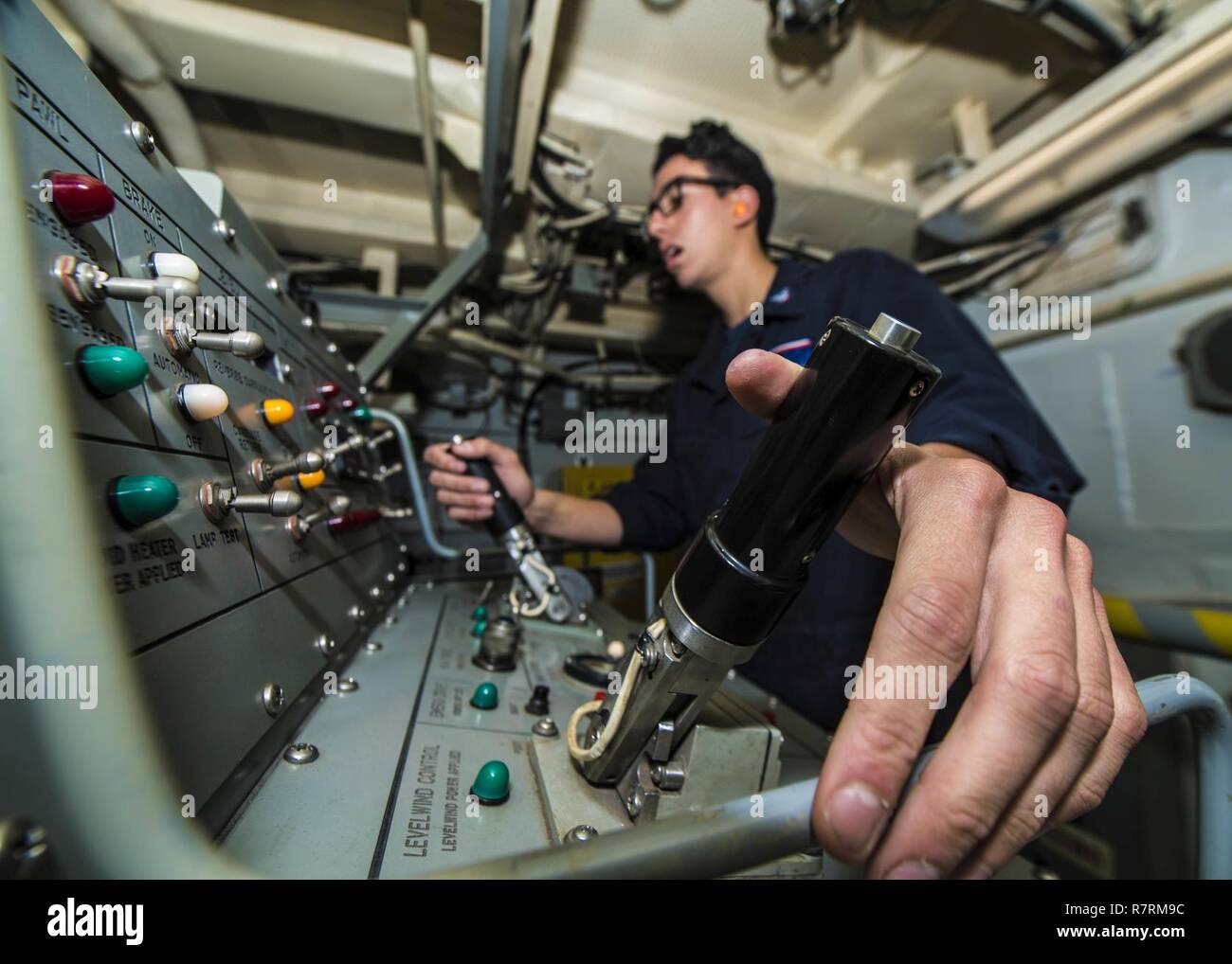 WATERS SURROUNDING THE KOREAN PENNINSULA (March 31, 2017) Sonar Technician (Surface) 3rd Class Juan Browndoig, from Pensacola, Florida, operates a multifunctional towed array (MFDA) console from Arleigh Burke-class guided-missile destroyer USS Barry (DDG 52) during a simulated submarine hunting exercise. Barry is participating in a surface ship anti-submarine warfare readiness and effectiveness measure exercise, a multi-national exercise designed to strengthen interoperability of the U.S. and Republic of Korea Navies. Stock Photo
