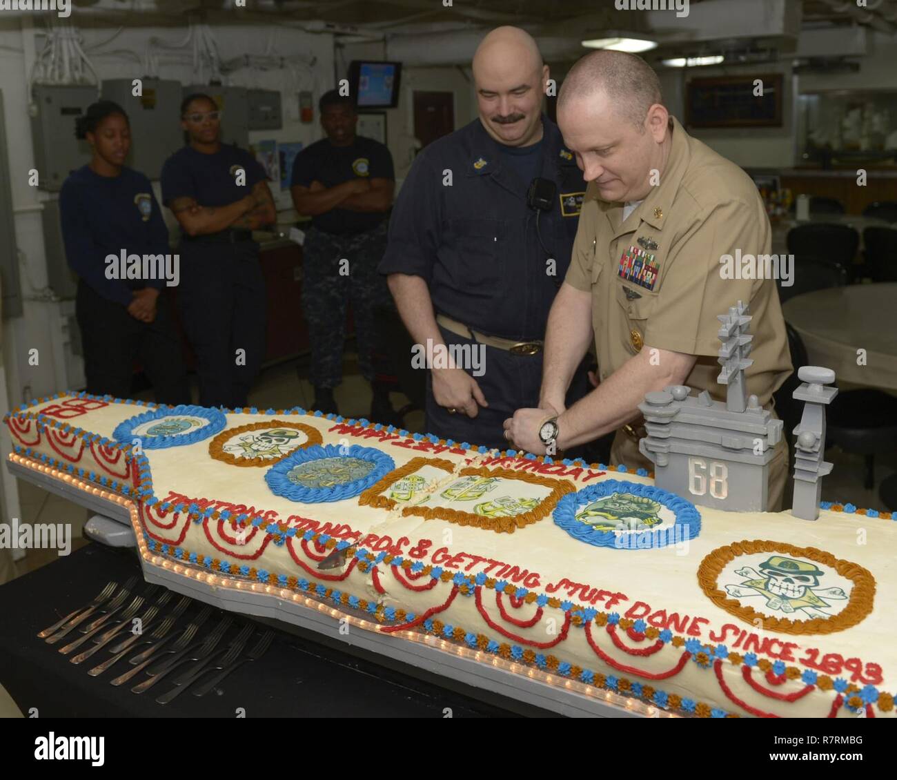 PACIFIC OCEAN (April 1, 2017) Command Master Chief Jimmy Hailey, assigned to the USS Nimitz (CVN 68), participates in the chief petty officer's 124th birthday cake cutting ceremony. Nimitz is underway conducting a composite training unit exercise with it's carrier strike group in preparation for an upcoming deployment. Stock Photo