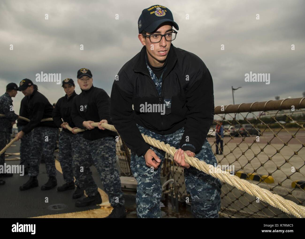 BUSAN, Republic of Korea (April 1, 2017) Sonar Technician (Surface) 3rd Class Juan Browndoig, from Pensacola, Florida, heaves a mooring line on the flight deck of Arleigh Burke-class guided-missile destroyer USS Barry (DDG 52) as the ship arrives in Busan, Republic of Korea for a scheduled port visit.  Barry is on patrol in the U.S. 7th Fleet area of operations in support of security and stability in the Indo-Asia-Pacific region. Stock Photo