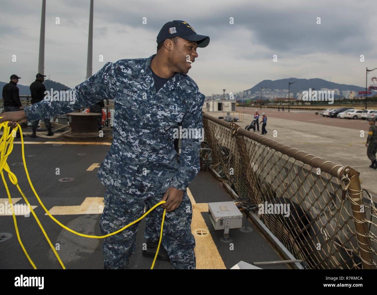 BUSAN, Republic of Korea (April 1, 2017) Electronics Technician 3rd Class Musa Shabazz, from San Francisco, California, tosses a mooring line from the flight deck of Arleigh Burke-class guided-missile destroyer USS Barry (DDG 52) as the ship arrives in Busan, Republic of Korea for a scheduled port visit.  Barry is on patrol in the U.S. 7th Fleet area of operations in support of security and stability in the Indo-Asia-Pacific region. Stock Photo