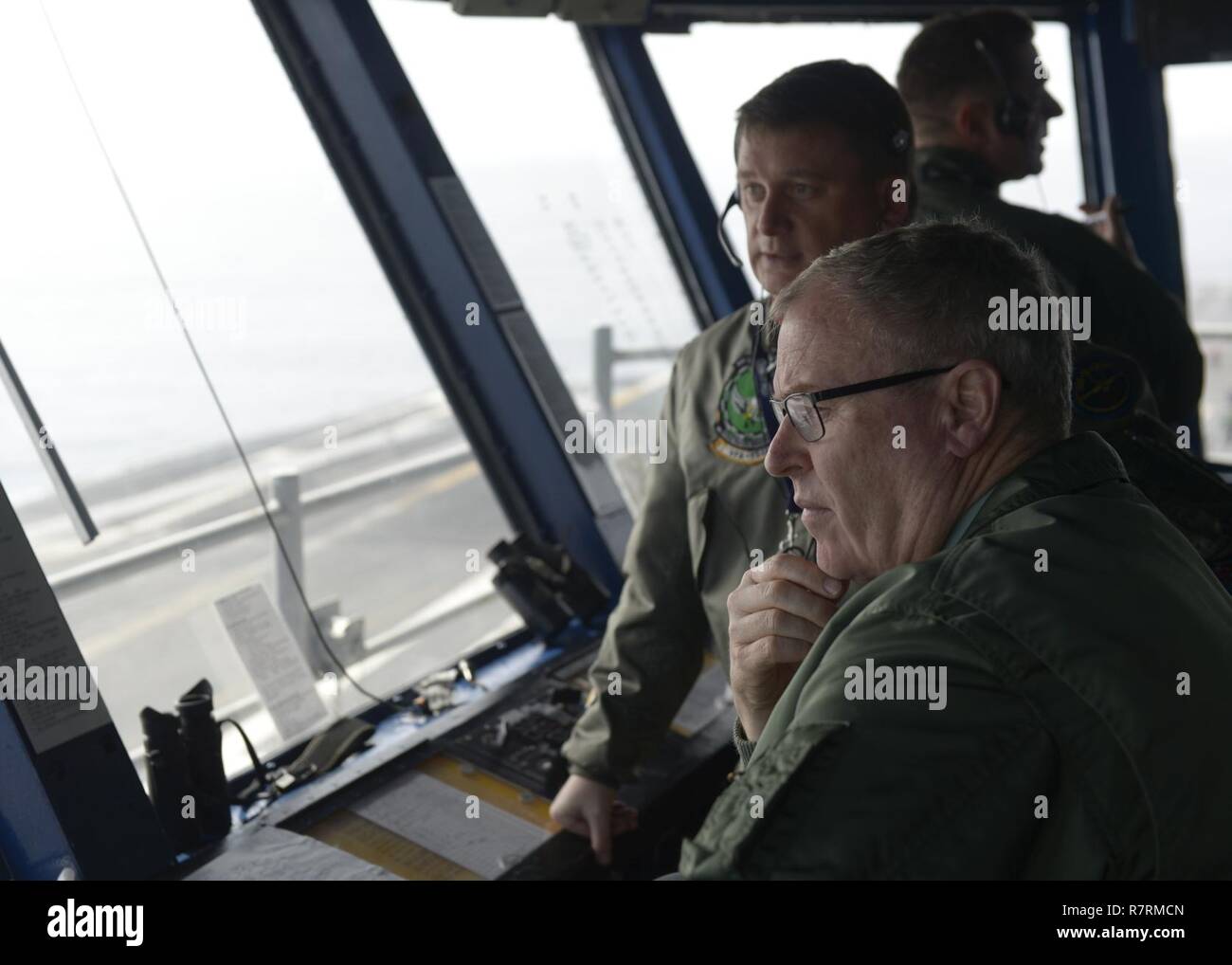 PACIFIC OCEAN (April 4, 2017) Deputy Secretary of Defense Robert Work observes flight operations aboard the aircraft carrier USS Nimitz (CVN 68). Nimitz is currently underway conducting Composite Training Unit Exercise (COMPTUEX) with the Nimitz Carrier Strike Group in preparation for an upcoming deployment. COMPTUEX tests a carrier strike group's mission-readiness and ability to perform as an integrated unit through simulated real-world scenarios. Stock Photo