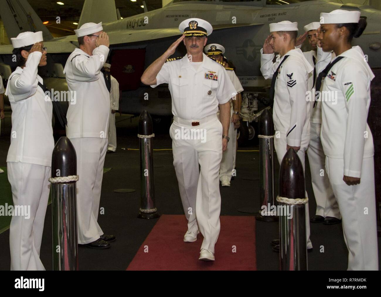 SINGAPORE (April 4, 2017)  Sideboys render honors to Capt. Doug Verissimo, commanding officer of the aircraft carrier USS Carl Vinson (CVN 70), during a reception in the ship’s hangar bay. Carl Vinson and it's carrier strike group are on a western Pacific deployment as part of the U.S. Pacific Fleet-led initiative to extend the command and control functions of U.S. 3rd Fleet. Stock Photo