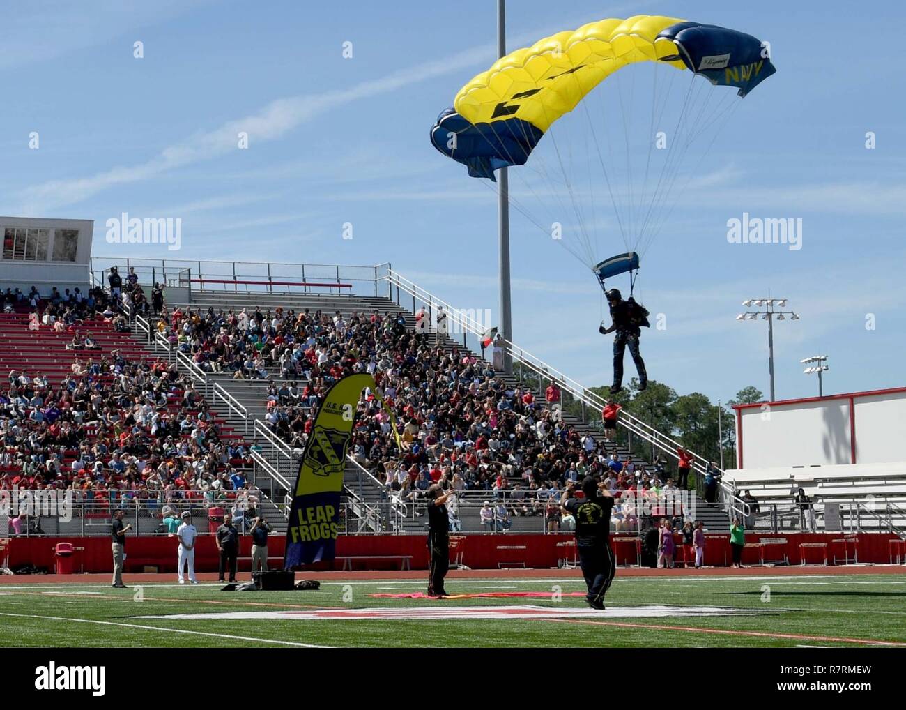 BILOXI, Miss. (April 4, 2017) A member of the U.S. Navy Parachute Team “The Leap Frogs” lands during a skydiving demonstration at the Biloxi High School stadium as part of Mississippi Gulf Coast Navy Week. Gulfport/Biloxi is one of select regions to host a 2017 Navy Week, a week dedicated to raise U.S. Navy awareness in through local outreach, community service and exhibitions. Stock Photo