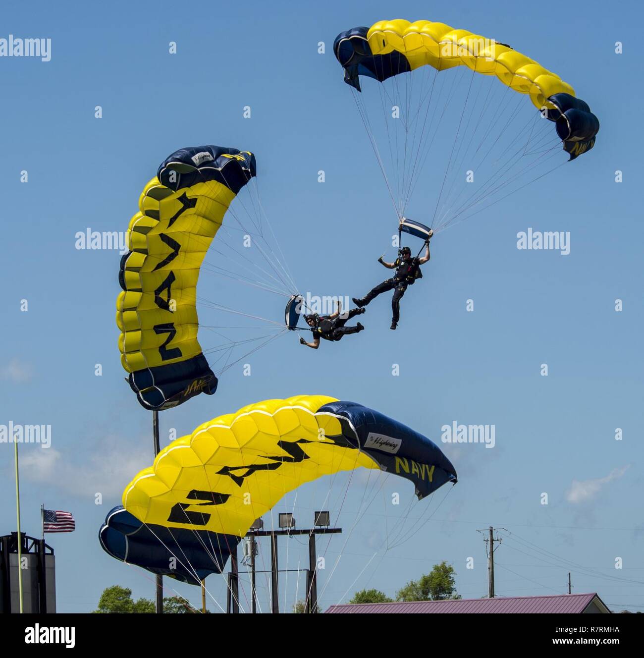 LONG BEACH, Miss. (April 03, 2017) Members of the U.S. Navy Parachute Team, the Leap Frogs, break from a down plane formation during a skydiving demonstration at Long Island High School that was part of Navy Week Gulfport/Biloxi. The Navy Week program serves as the Navy's principal outreach effort in areas of the country without a significant Navy presence. Stock Photo