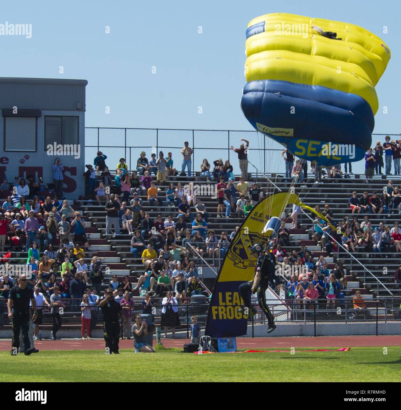 LONG BEACH, Miss. (April 03, 2017) Special Operator 1st Class Timmy Holland, member of the U.S. Navy Parachute Team, the Leap Frogs, lands on a football field during a skydiving demonstration at Long Beach High School that was part of Navy Week Gulfport/Biloxi. The Navy Week program serves as the Navy's principal outreach effort in areas of the country without a significant Navy presence. Stock Photo