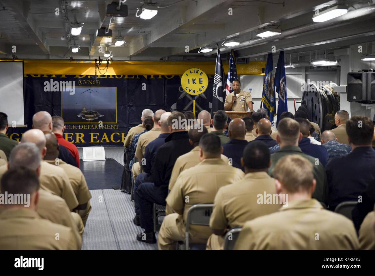 ATLANTIC OCEAN (April 1, 2017) Command Master Chief Tyrone M. Blockton,  assigned to the aircraft carrier USS Dwight D. Eisenhower (CVN 69), addresses the crew during the chief's 124th birthday ceremony.  The ship and its carrier strike group are currently underway conducting a sustainment exercise in support of the optimized fleet response plan. Stock Photo