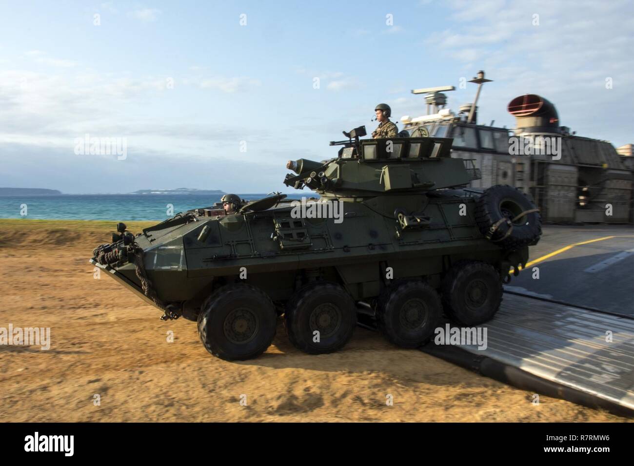 KIN BLUE BEACH, Okinawa (April 5, 2017) Marines, assigned to the 31st Marine Expeditionary Unit (MEU), disembark a light armored vehicle (LAV) from landing craft air cushion (LCAC) 29, assigned to Naval Beach Unit (NBU) 7, during a 31st Marine Expeditionary Unit (MEU) offload from the amphibious assault ship USS Bonhomme Richard (LHD 6). Bonhomme Richard, flagship of the Bonhomme Richard Expeditionary Strike Group, with embarked 31st MEU, is on a patrol, operating in the Indo-Asia-Pacific region to enhance warfighting readiness and posture forward as a ready-response force for any type of cont Stock Photo