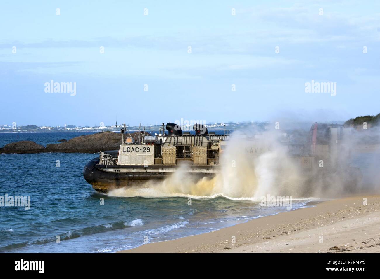 KIN BLUE BEACH, Okinawa (April 5, 2017) Landing craft air cushion (LCAC) 29, assigned to Naval Beach Unit (NBU) 7, departs the beach during a 31st Marine Expeditionary Unit (MEU) offload from the amphibious assault ship USS Bonhomme Richard (LHD 6). Bonhomme Richard, flagship of the Bonhomme Richard Expeditionary Strike Group, with embarked 31st MEU, is on a patrol, operating in the Indo-Asia-Pacific region to enhance warfighting readiness and posture forward as a ready-response force for any type of contingency. Stock Photo
