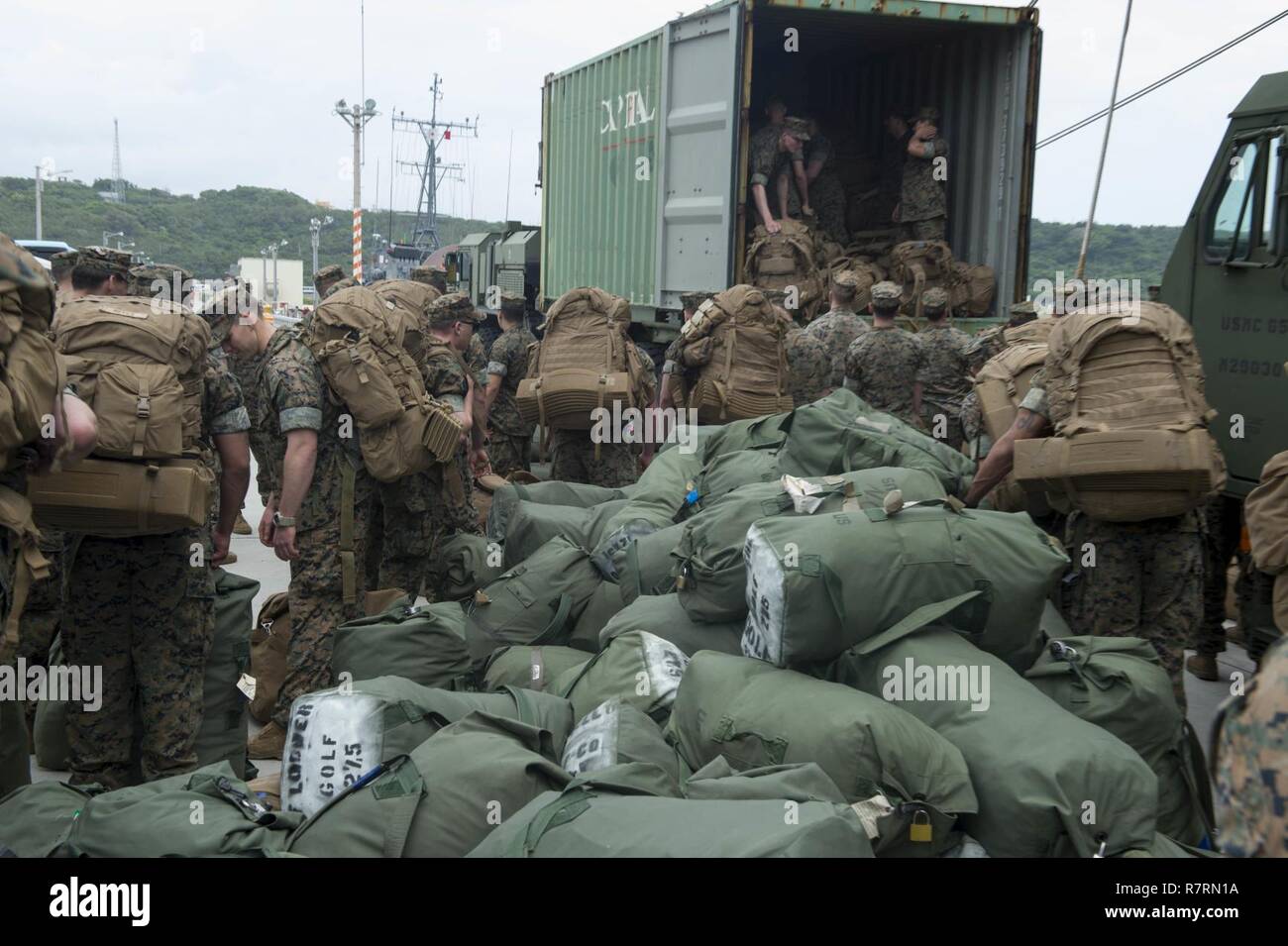 WHITE BEACH, Okinawa (April 6, 2017) Marines, assigned to the 31st Marine Expeditionary Unit (MEU), load gear into a logistic vehicle system replacement (LVSR) during an offload from the amphibious assault ship USS Bonhomme Richard (LHD 6). Bonhomme Richard, flagship of the Bonhomme Richard Amphibious Ready Group is on a patrol, operating in the Indo-Asia-Pacific region to enhance warfighting readiness and posture forward as a ready-response force for any type of contingency. Stock Photo